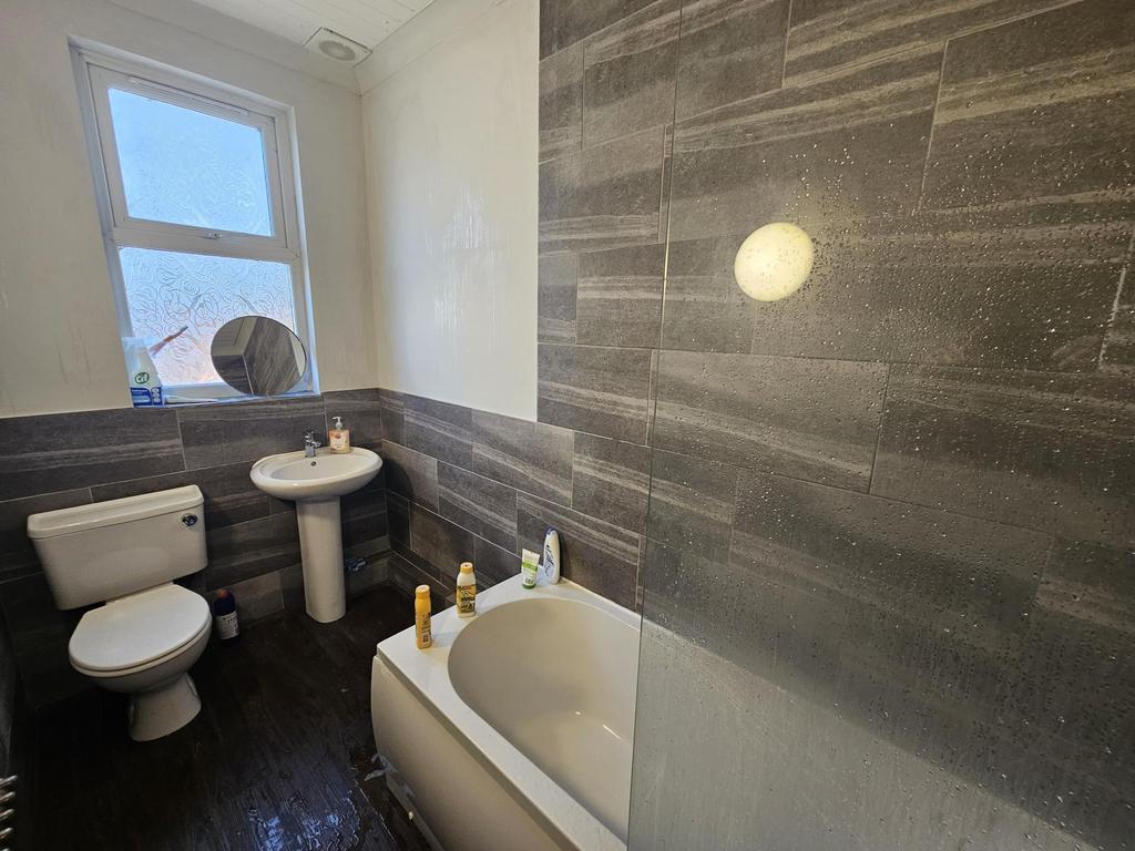 Bright bathroom with bath and modern tiles...