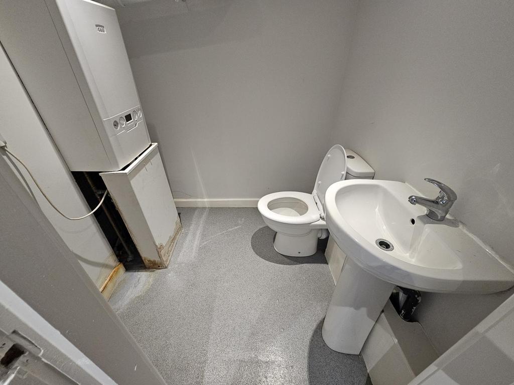 Clean compact bathroom with basin and WC...