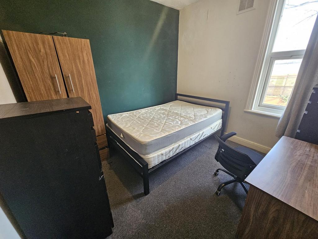 Bright bedroom with bed, desk and wardrobe...
