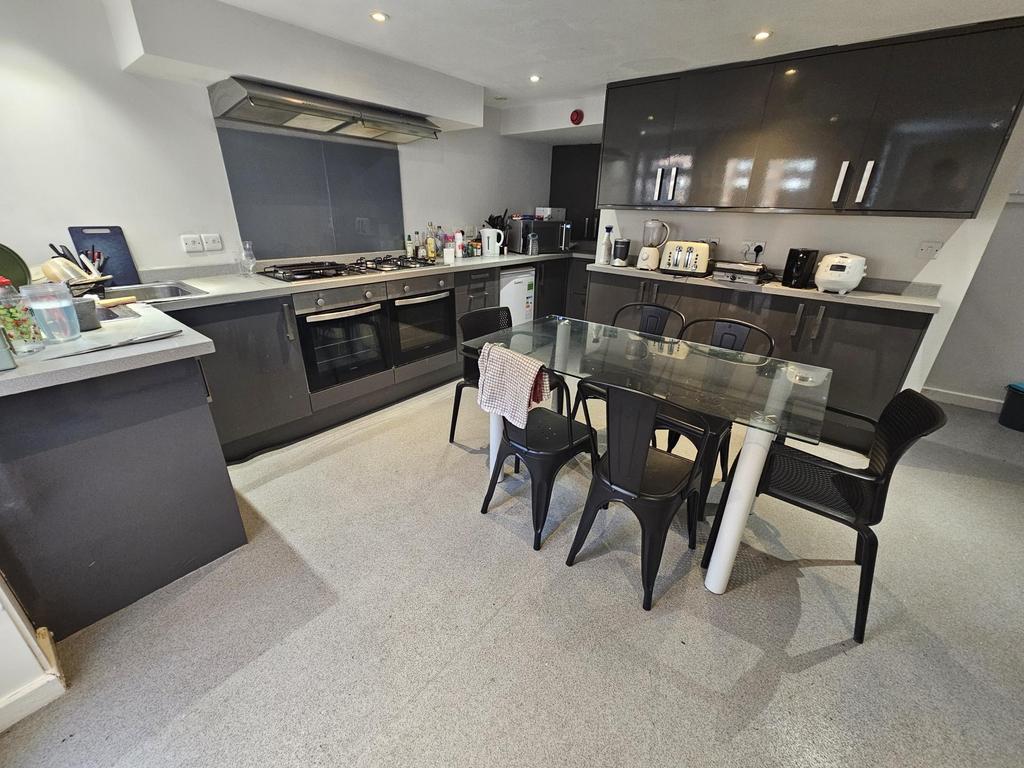 Modern kitchen with dining table and appliances...