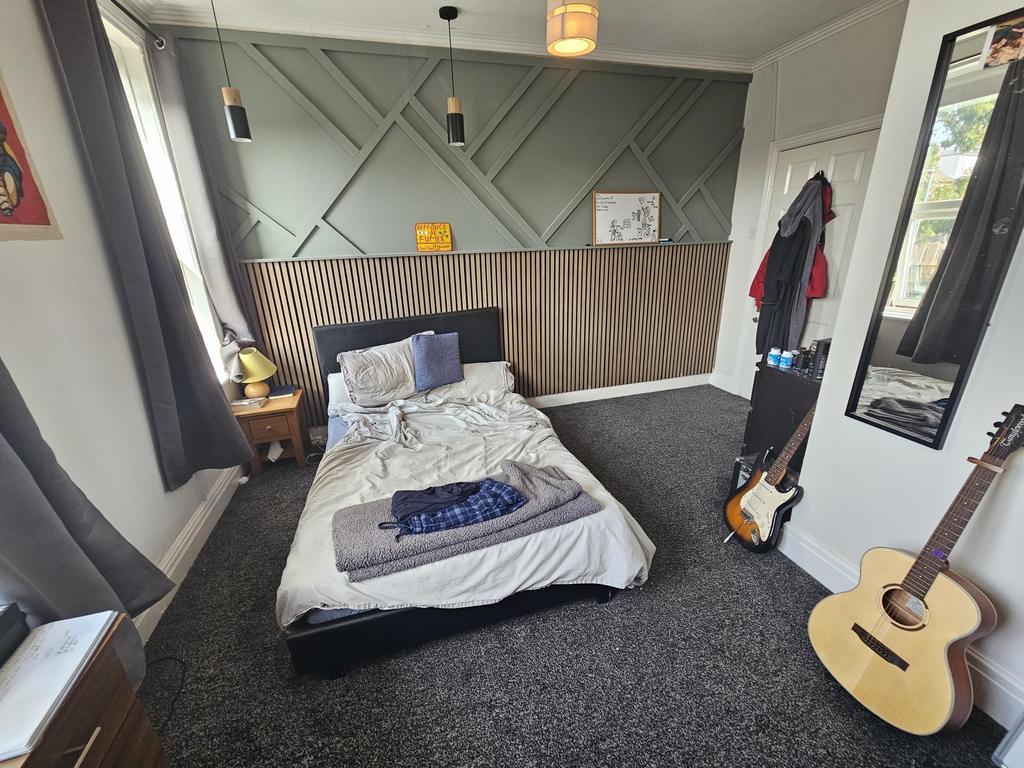 Bright double bedroom with stylish wall panelli...