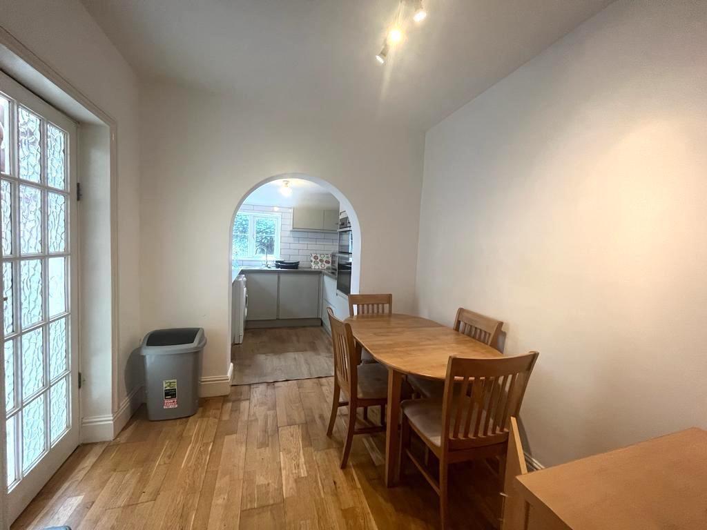 Bright dining area opening through an arched do...