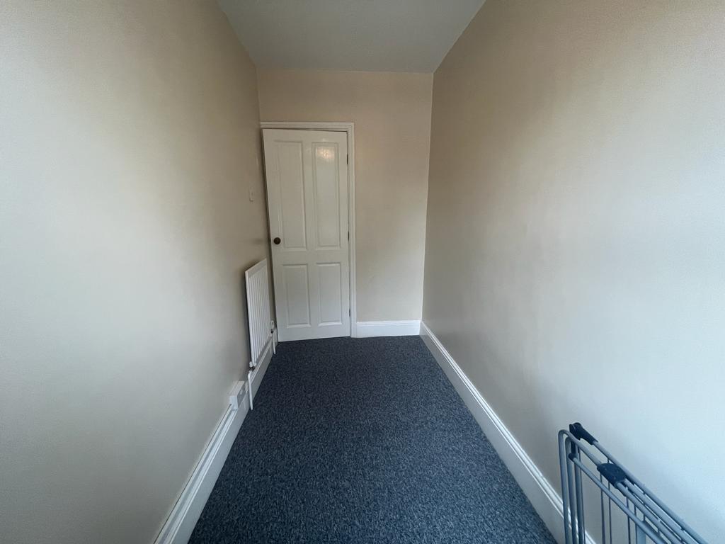 Narrow internal corridor with fresh neutral pai...