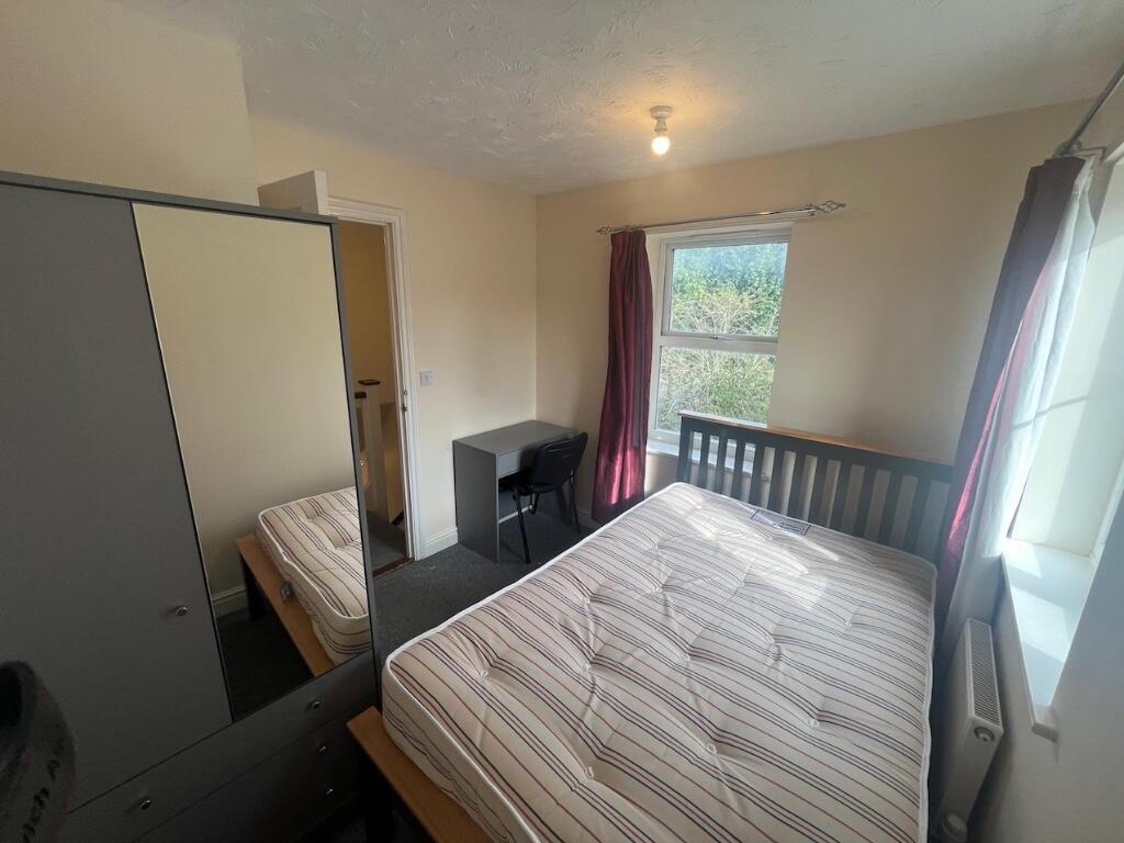 Bright, neatly presented bedroom with a double ...