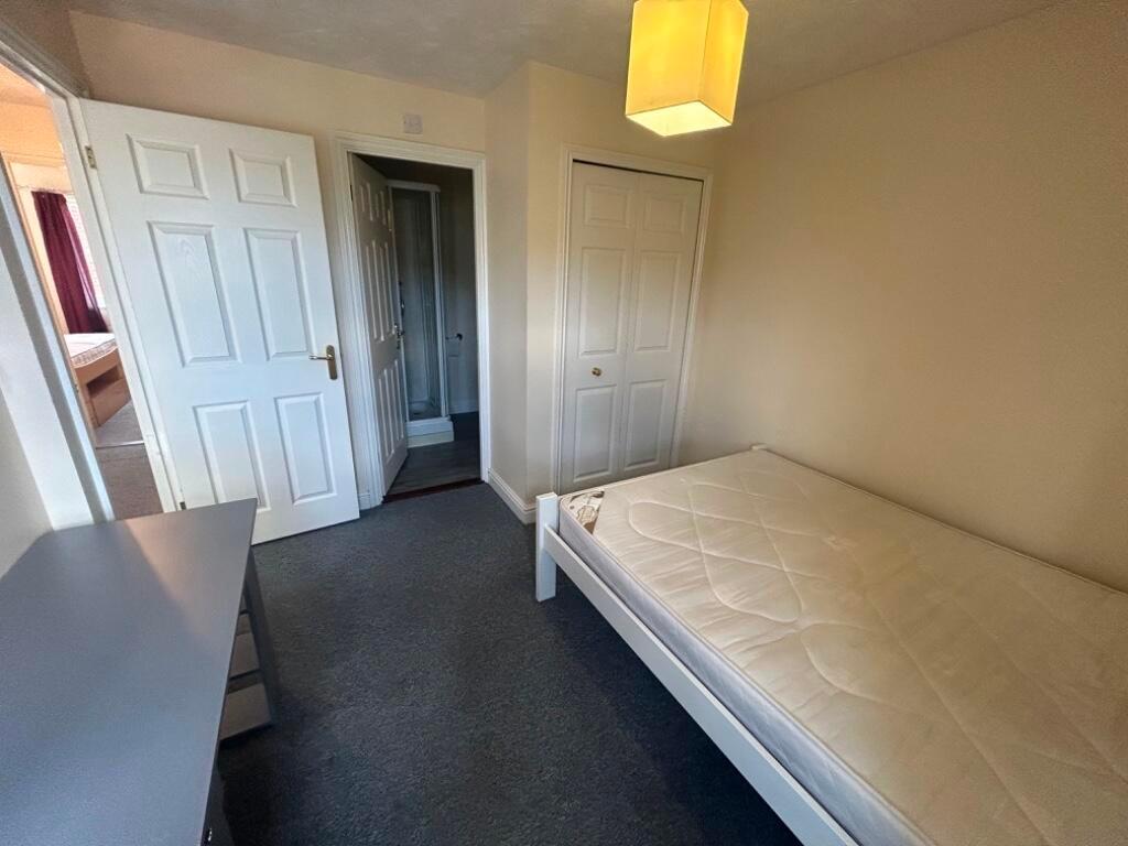Bright, simply furnished bedroom with a single ...