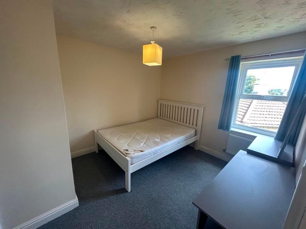 Bright, tidy bedroom with a white double bed fr...