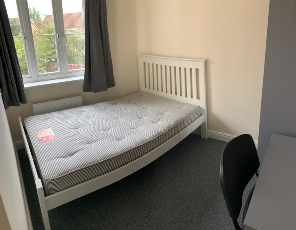 Bright, tidy bedroom with a double bed, neutral...