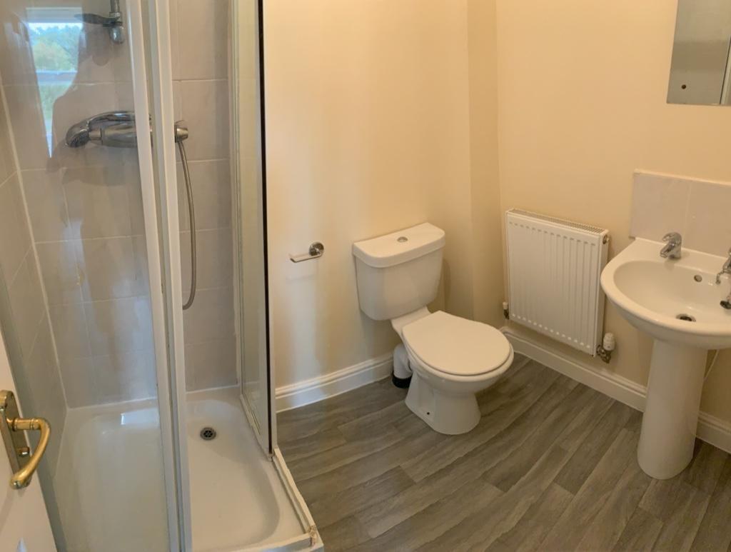 Bright, well-maintained bathroom with a corner ...