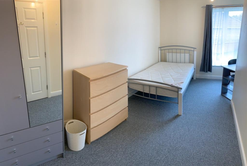 Bright, tidy single bedroom with a metal bed fr...
