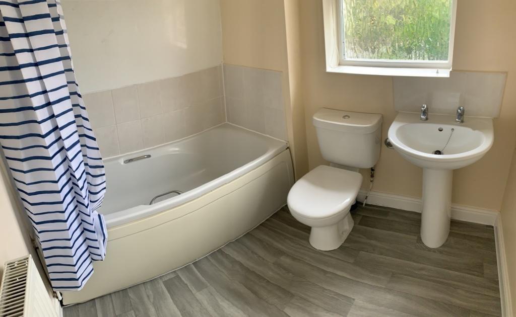 Bright, well-maintained bathroom with a modern ...