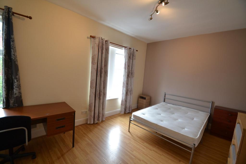 Bright and inviting bedroom featuring a comfort...