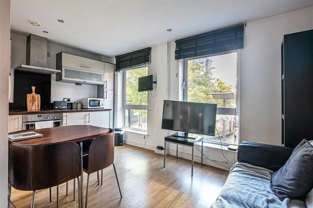 Bright and modern living room featuring large w...