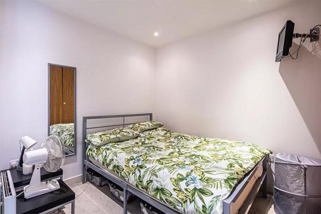 A cozy double bedroom featuring a neatly made b...