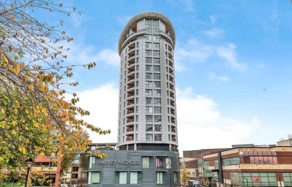 Tall modern cylindrical apartment tower with a ...