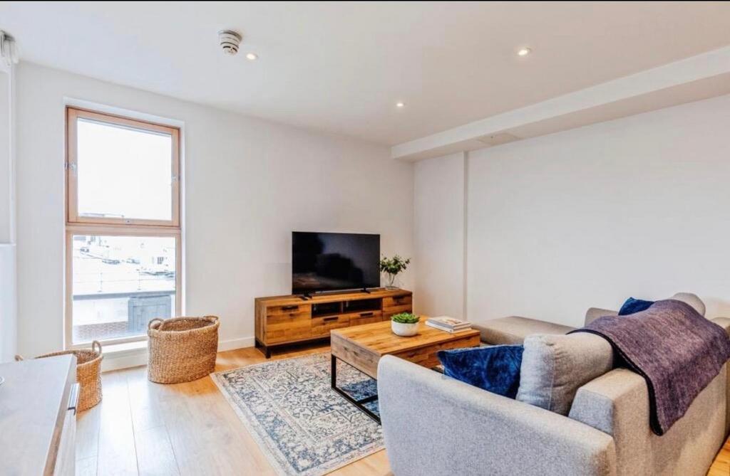 Bright, modern living room with a large window,...