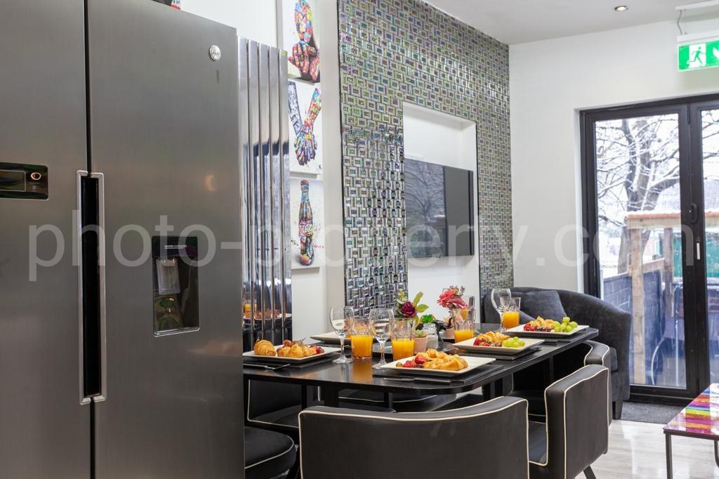 Sleek open-plan kitchen/dining area with a mode...
