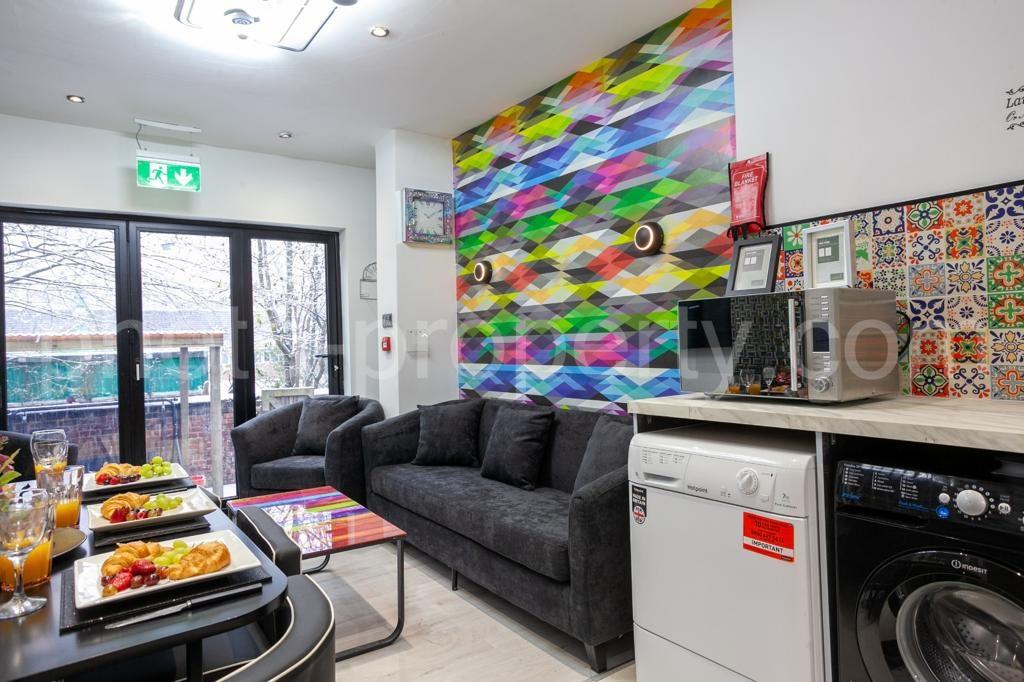 Bright, modern communal lounge with comfortable...