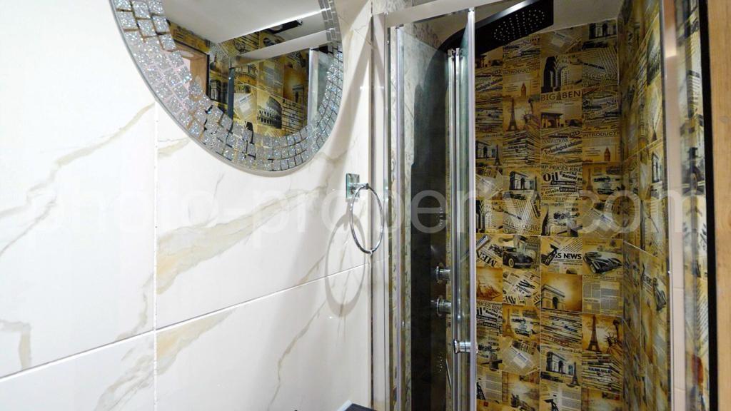 Modern bathroom with a glass-enclosed shower cu...