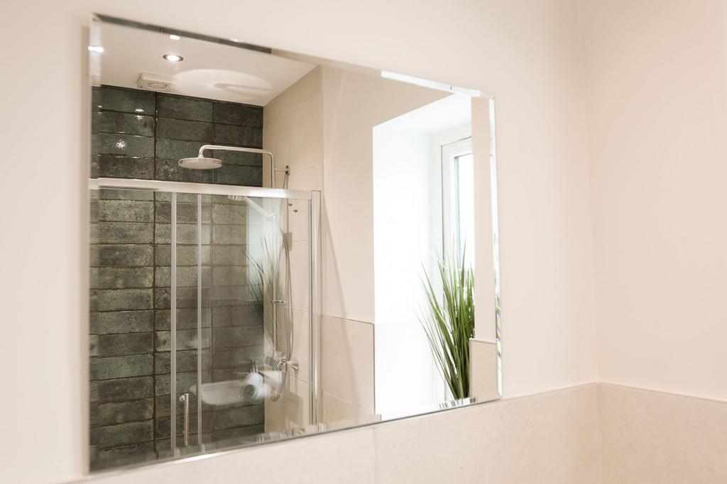 Bright modern bathroom with glass shower...