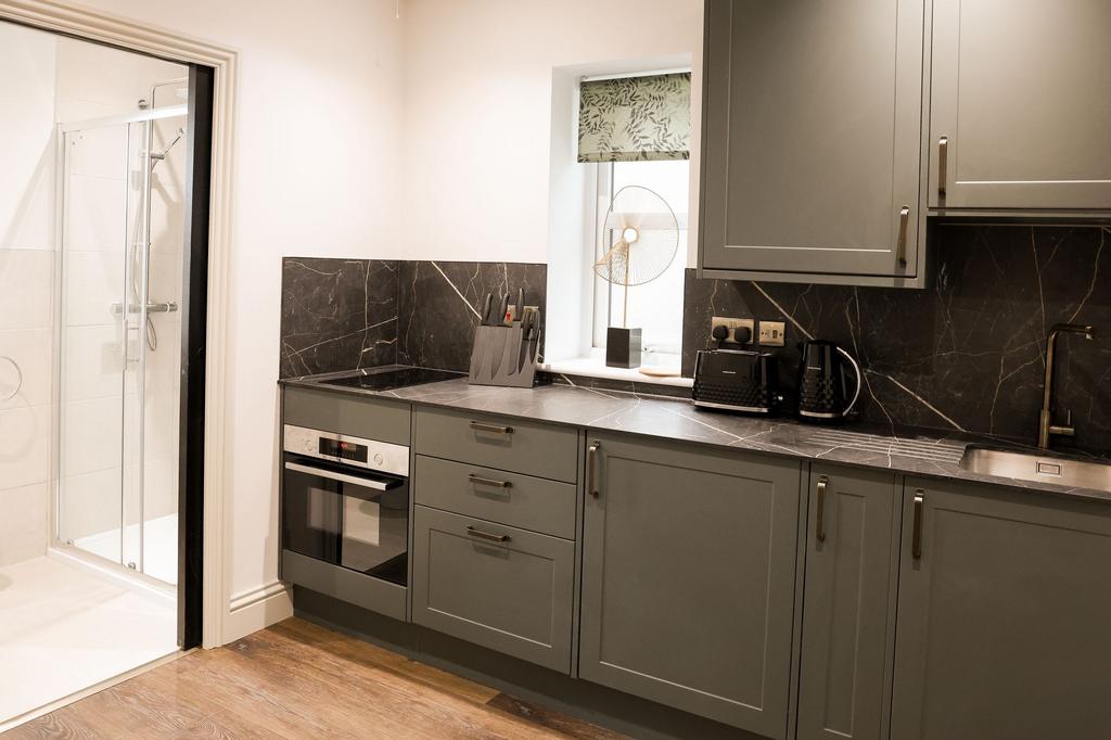 Modern kitchen with marble surfaces and integra...