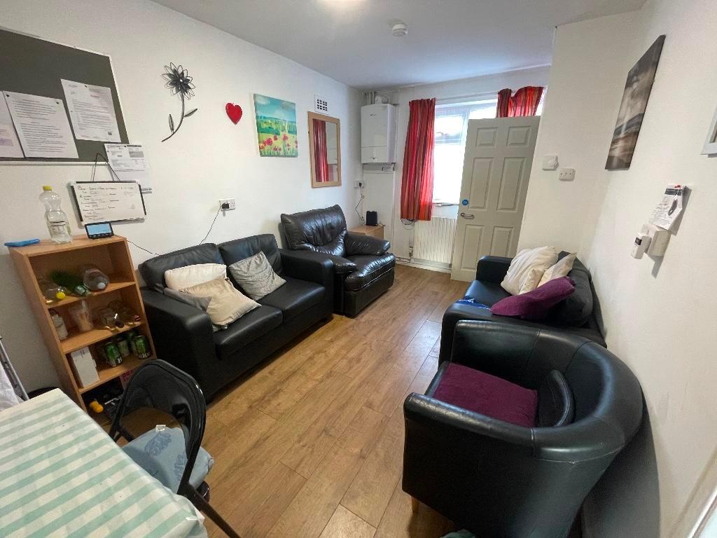 Bright, welcoming communal lounge with wood-eff...