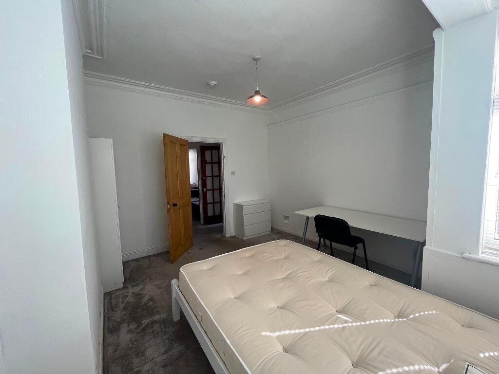 Bright, neutral double bedroom with a comfortab...
