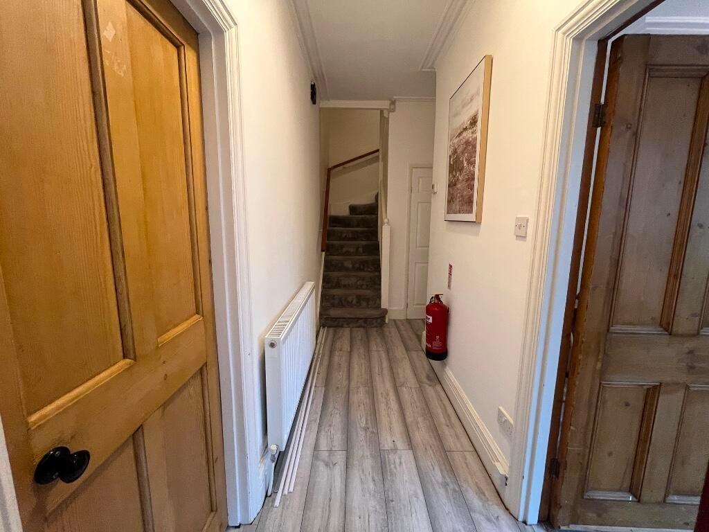 Bright, well-maintained hallway with modern woo...