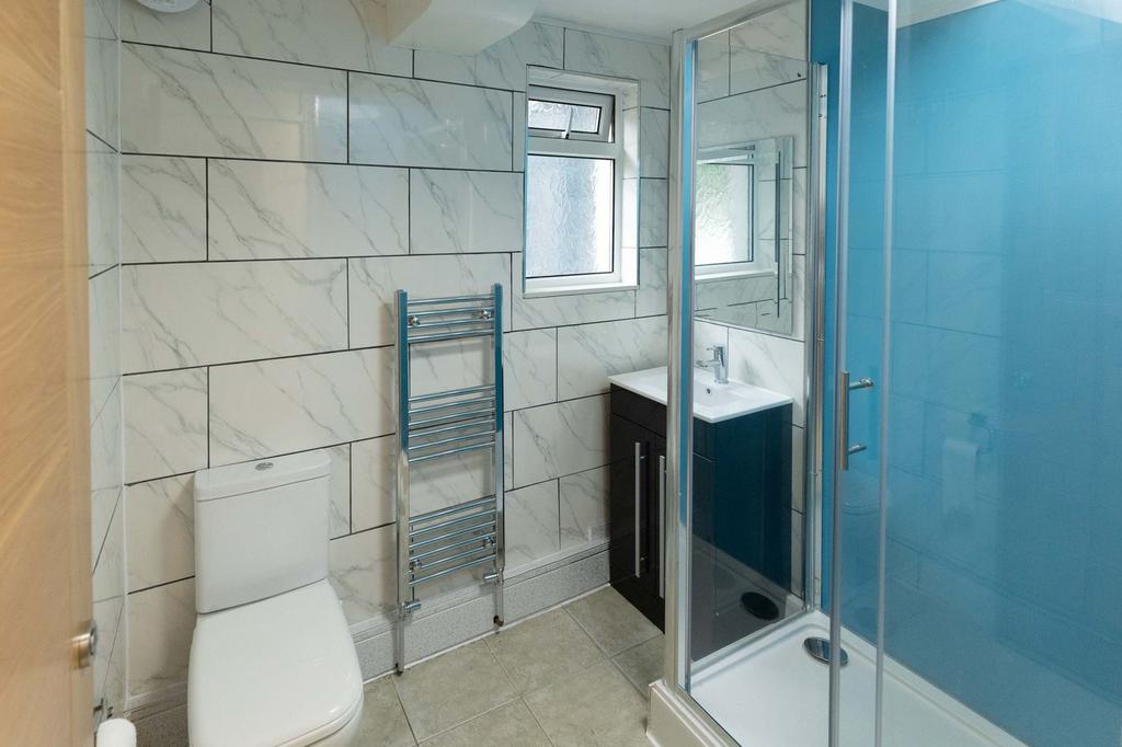 Modern bathroom featuring large marble tiles, a...