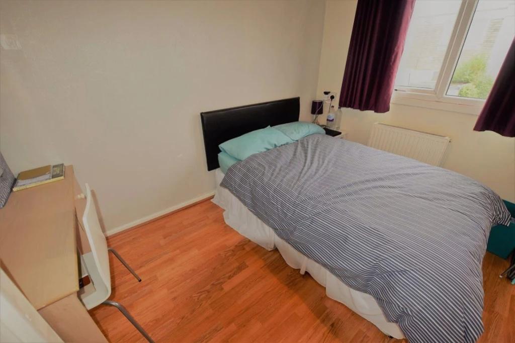 Bright, neatly presented bedroom with a comfort...