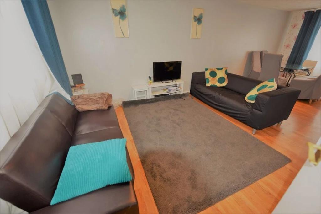 Bright, comfortable living room with two sofas,...