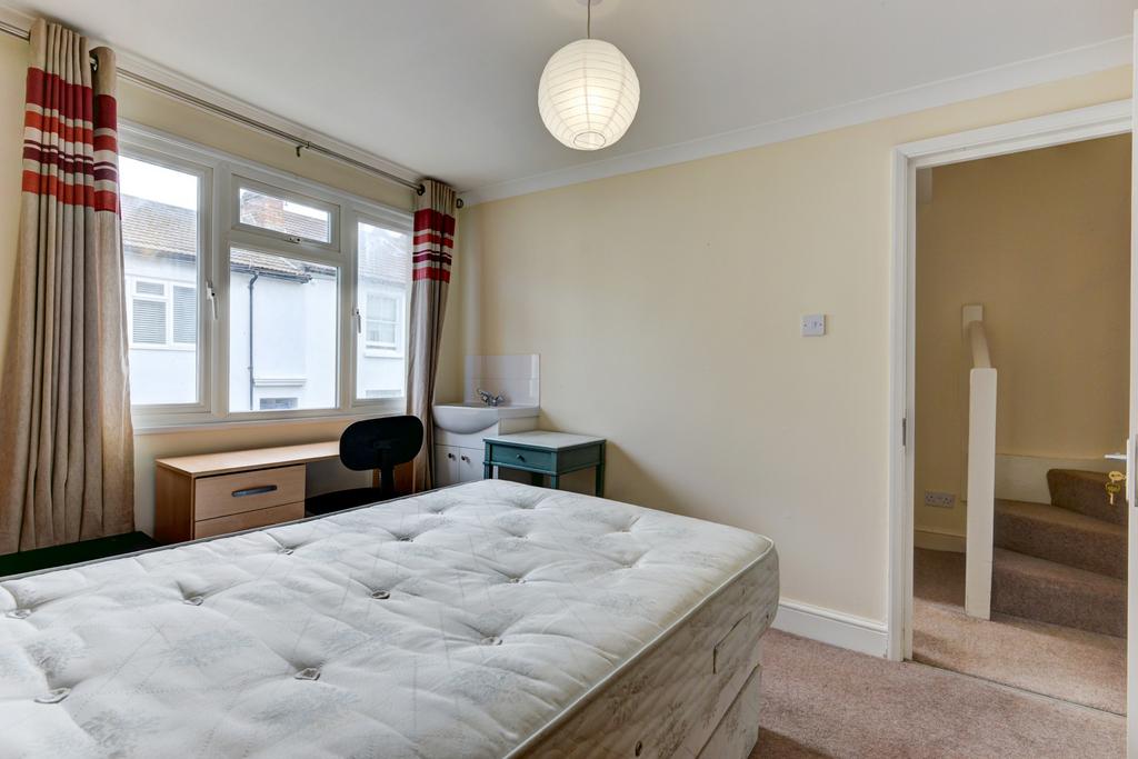 Bright and welcoming bedroom featuring a large ...