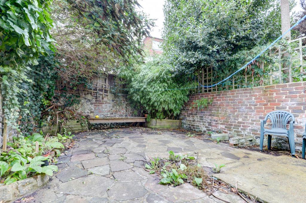 Pretty private paved garden with mature greener...