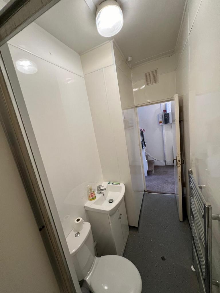 Compact bathroom with modern fixtures including...