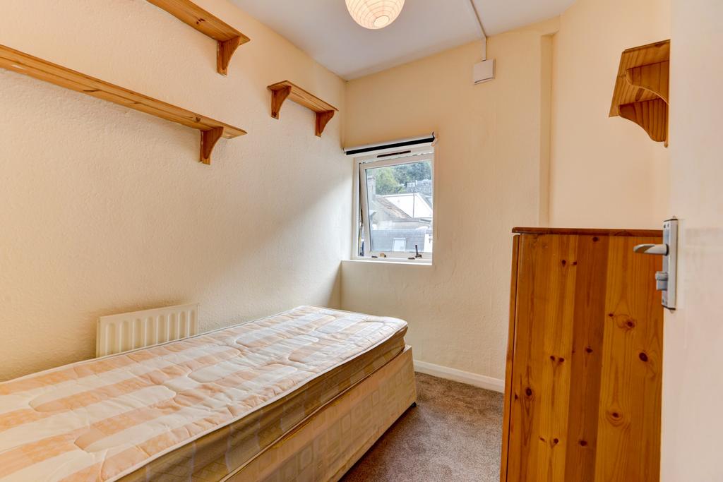 A modest bathroom with a clean appearance, feat...