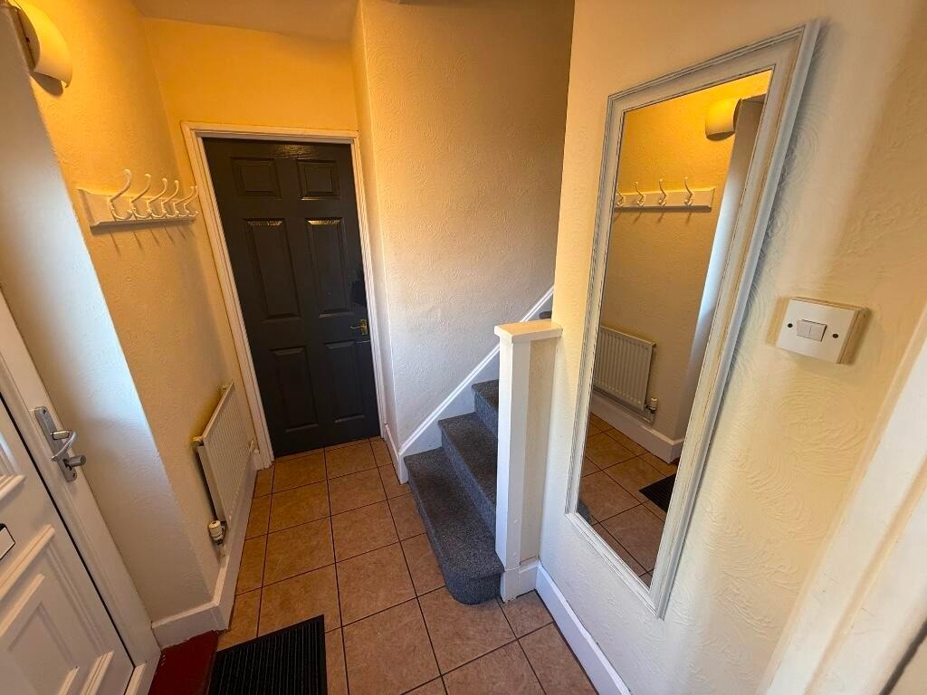 Welcoming entrance hallway with tiled flooring,...