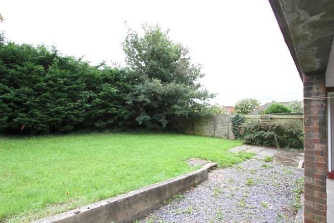 Private rear garden with a level lawn, mature h...