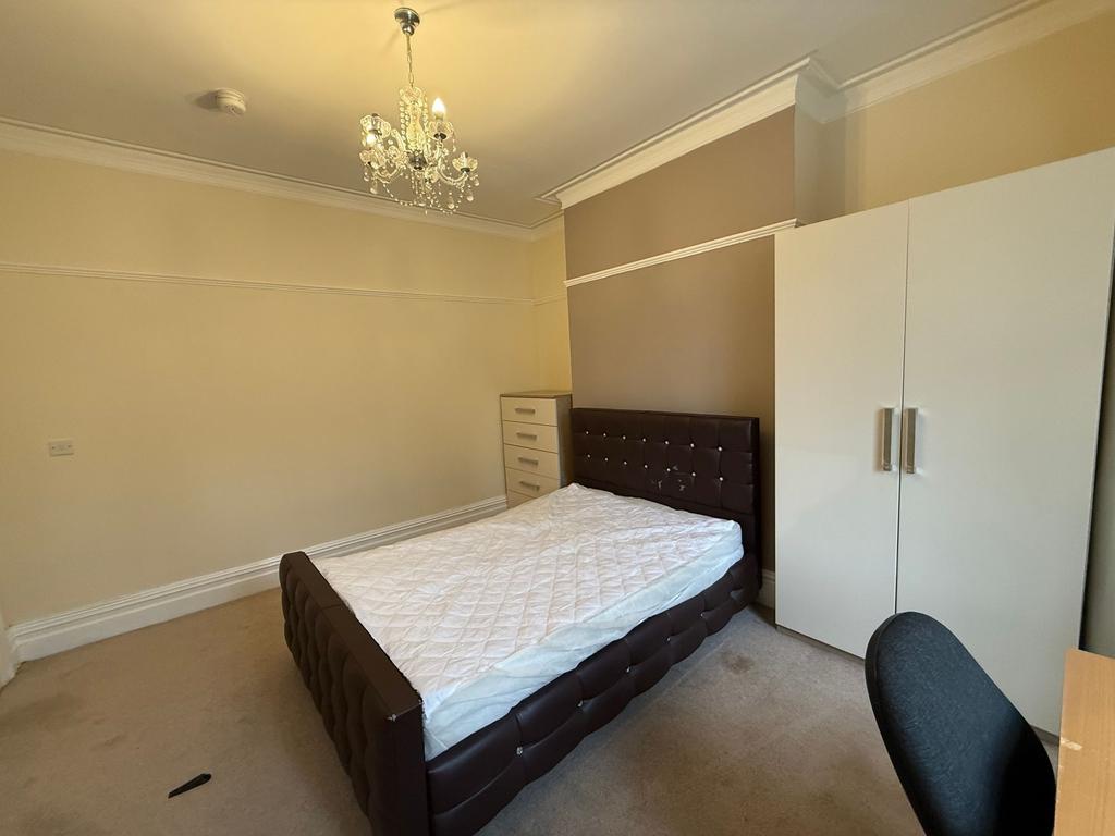 Bright, neutrally decorated double bedroom with...