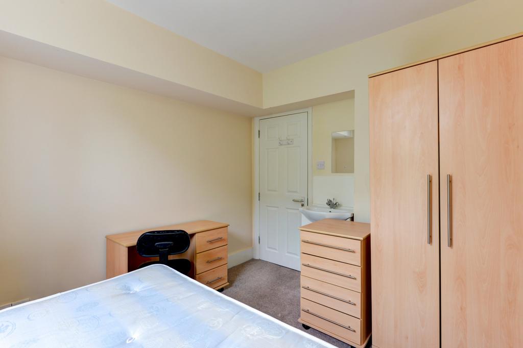 Bright, simply furnished bedroom with wardrobe,...
