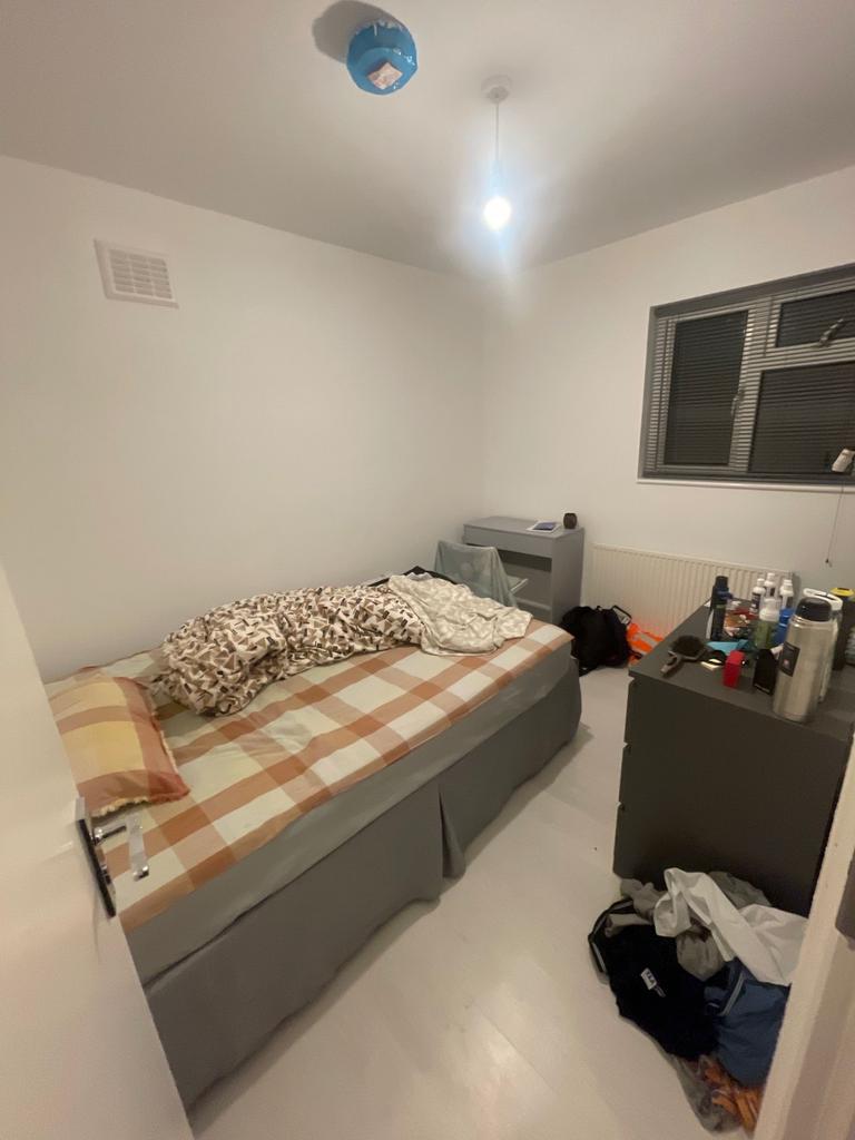 Compact, simply furnished bedroom with a neatly...