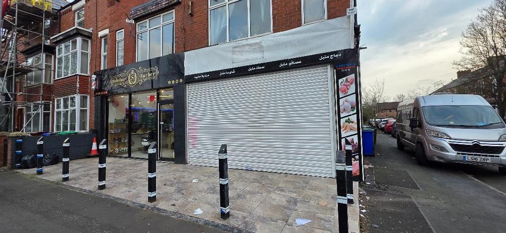 Ground-floor retail frontage with shutter and s...