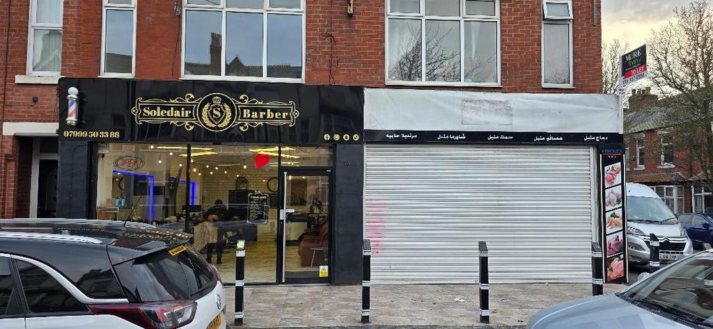 Street-facing shopfront with modern barber...