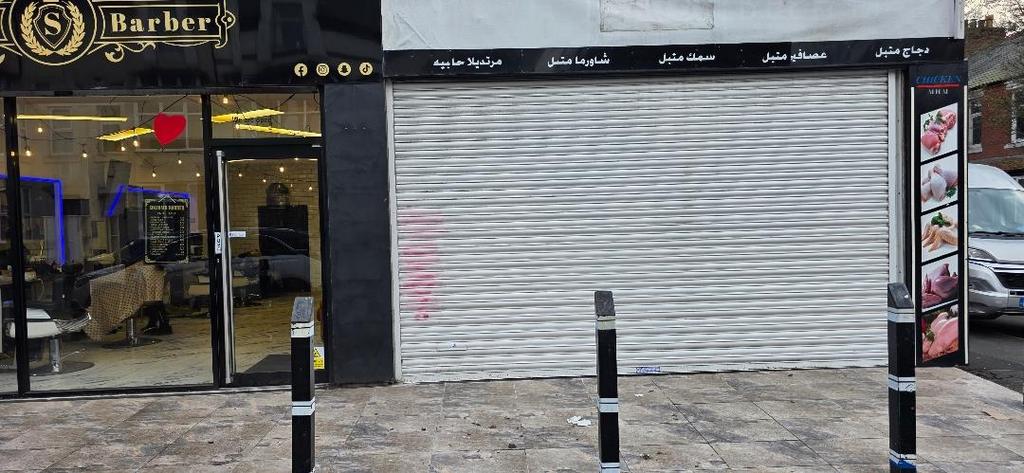 Shopfront with barber and roller-shutter unit...