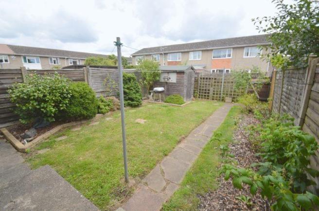 Private rear garden with a laid lawn, paved pat...