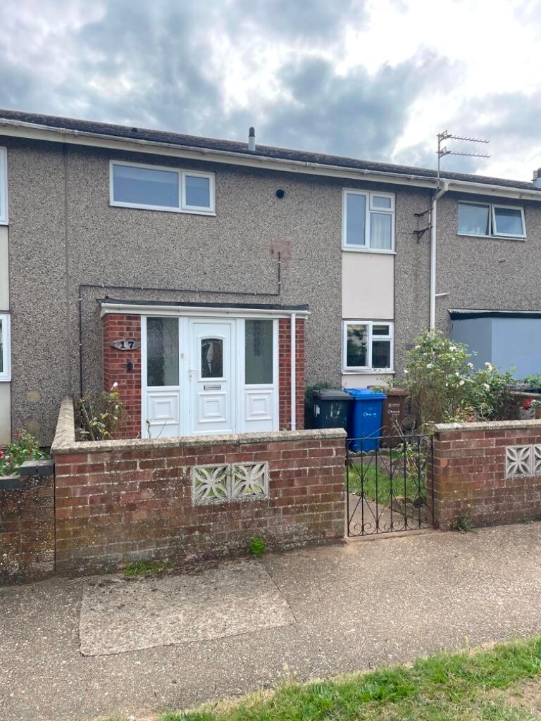 Terraced house exterior with a small front gard...