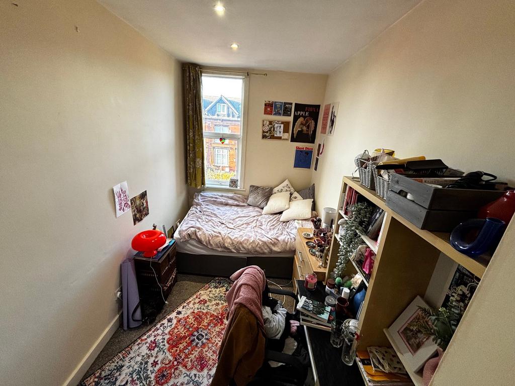 Cosy single bedroom with a double bed pushed ag...