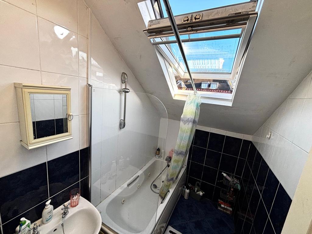 Bright loft bathroom with a skylight over a bat...