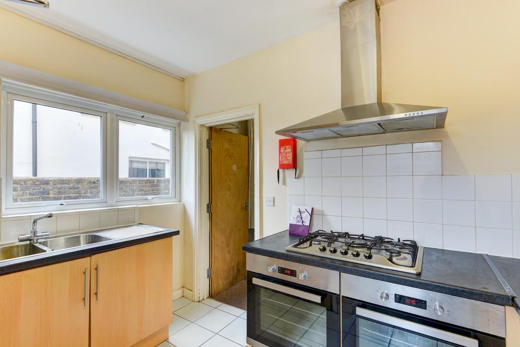 Bright kitchen with large window, modern gas ho...