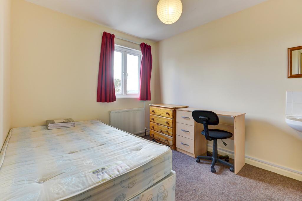 A comfortable double bedroom featuring a bed, a...