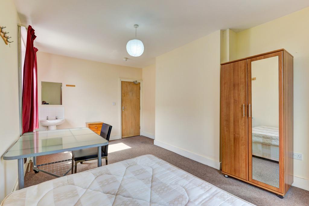Bright and welcoming bedroom featuring a comfor...