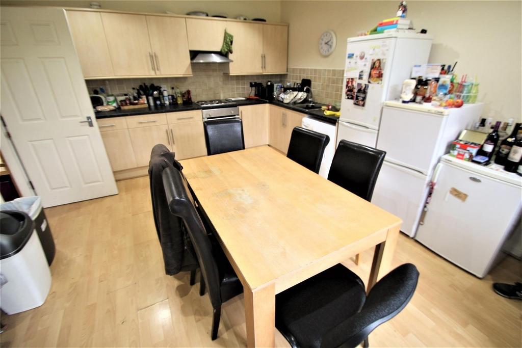 A functional kitchen with wooden cabinets, blac...